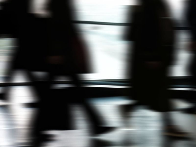 Dynamic silhouette of a person moving gracefully against a neutral background